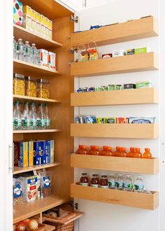 an organized pantry with wooden shelves filled with food