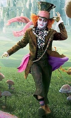 there is a man dressed as the mad hatter running in front of some mushrooms