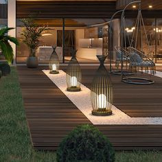 some lights are lit up on the wooden decking near an outdoor area with swings and chairs