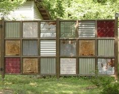 a wooden fence with many different colored panels on it