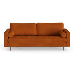 an orange couch sitting on top of a white floor