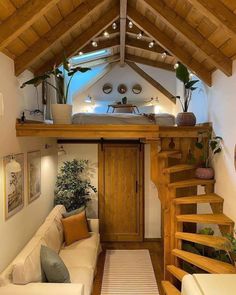 a living room filled with furniture under a wooden roof