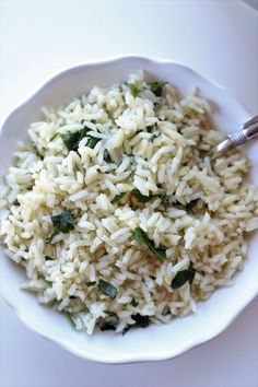 a white bowl filled with rice and spinach