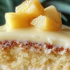 there is a piece of cake with white frosting and pineapples on top