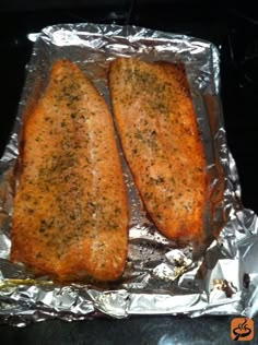 two fish fillets sitting on top of aluminum foil