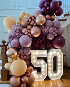 the number 50 is surrounded by balloons and lights