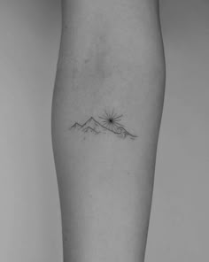 a woman's leg with a small tattoo on it