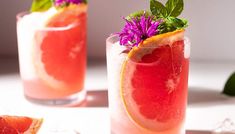 two glasses filled with watermelon and garnished with flowers