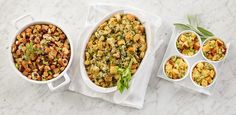 three dishes of food on a marble countertop, one is filled with stuffing and the other has vegetables