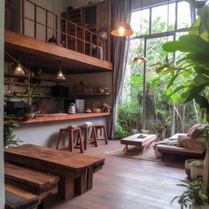 a living room filled with lots of furniture and plants on top of wooden shelves next to a window