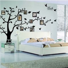 a bedroom with a tree and pictures on the wall