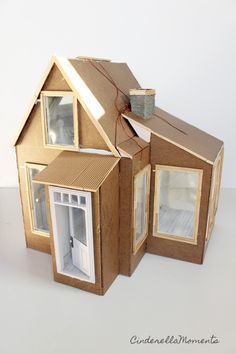 a cardboard doll house is shown with the door open