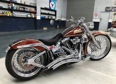 a red and black motorcycle parked in a garage