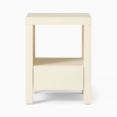 the side table is white and has an open shelf on it's left side