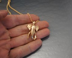 "one of my favorite sculptures that i have done is the elephant. ( shown in the last photo ) so i used that as inspiration for this pendant. at 1 1/4 tall he is a bit larger than my other pendants but....elephants are big. the chain is a 2.5 mm oval rolo link. 20 \" long . if you need a longer chain just ask or if you dont need a chain order it without . this guy is also available in 14 or 18 k gold . yellow , rose or white. ask for a quote" Gold Pendants For Men, Mens Wedding Rings Gold, Bull Elephant, Ganesha Pendant, Gold Pendent, Unique Pendant Necklace, Gold Chain Design, Mens Gold Jewelry, Chocker Necklace