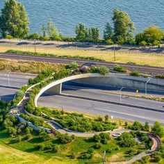 an aerial view of the highway and bridge overpasss with trees on both sides