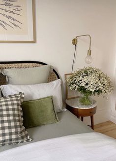 a bed with pillows and flowers on it