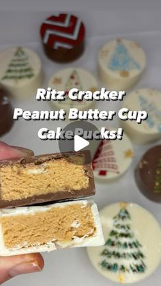 a hand holding a piece of peanut butter cupcake next to some christmas trees and cookies