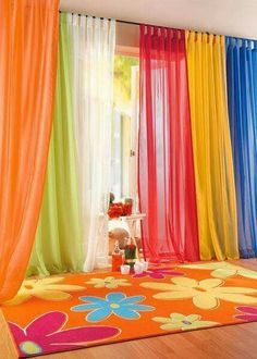 colorful curtains are hanging in front of a window