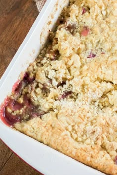 a close up of a casserole dish on a table with utensils