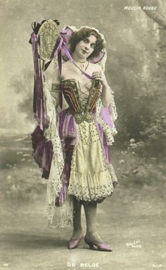 an old photo of a woman dressed in period clothing and holding a fan on her shoulder