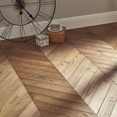 a clock sitting on top of a wooden floor