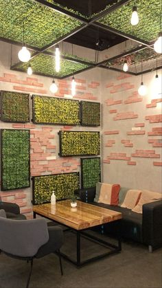 a living room filled with furniture and walls covered in green mossy wall coverings