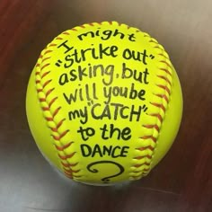 a yellow softball with words written on it