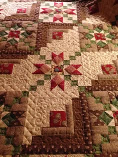 a quilted bed with red and green stars on it