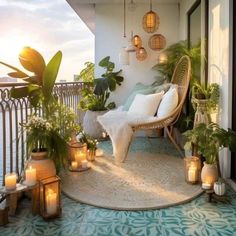 a balcony with potted plants and candles on the floor next to a chair that is sitting on a rug