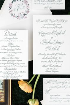 the wedding stationery is laid out on top of each other