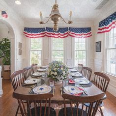 the dining room table is set with plates and place settings for four people to eat