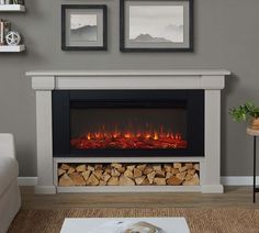 a living room with a fireplace and pictures on the wall