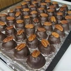 chocolate covered candies with pecans on top