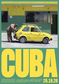 a yellow car is parked in front of a green building with the word cuba on it