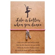 a pink string bracelet with ballet shoes on it that says, life is better when you dance