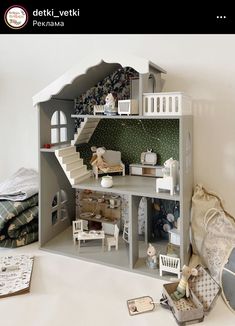 a doll house with furniture and accessories on the floor in front of a white wall