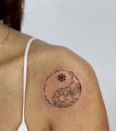 a woman with a tattoo on her shoulder