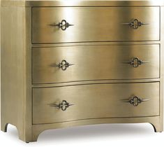 a gold dresser with four drawers and two handles