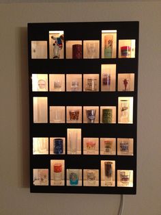 a wall mounted display with many different items on it's sides and lights in the middle