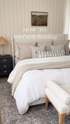 a white bed sitting in a bedroom next to a window with the words how to hotel style bedding on it