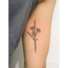 a woman's arm with a flower tattoo on the left side of her arm