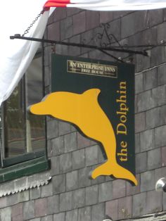 a sign on the side of a building that says dolphin inn