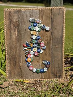 a wooden sign made out of beer bottle caps