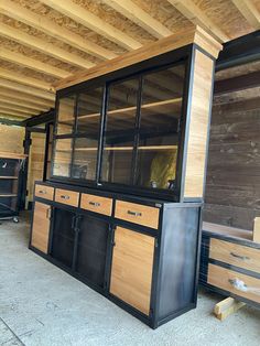 the inside of a building with wooden shelves and cabinets