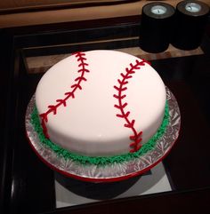 a baseball cake is decorated with green and red icing