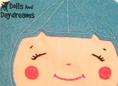 a drawing of a child's face on a blue background with words dolls and daydreams