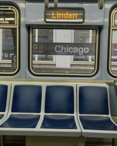 an empty subway car with blue seats on the front and windows in chicago, illinois