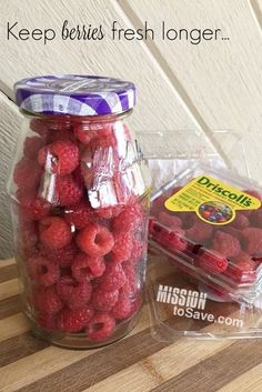 some raspberries are in a jar on a table