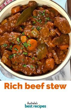 a bowl filled with beef stew on top of a table